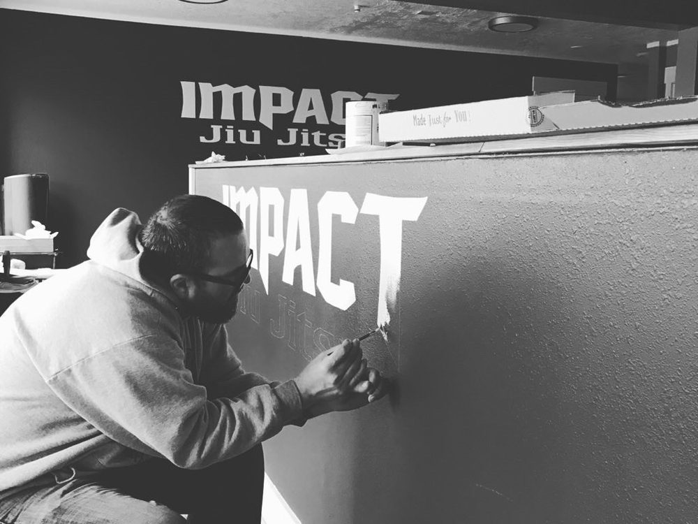 Hand painted wall lettering for Impact Jiu Jitsu